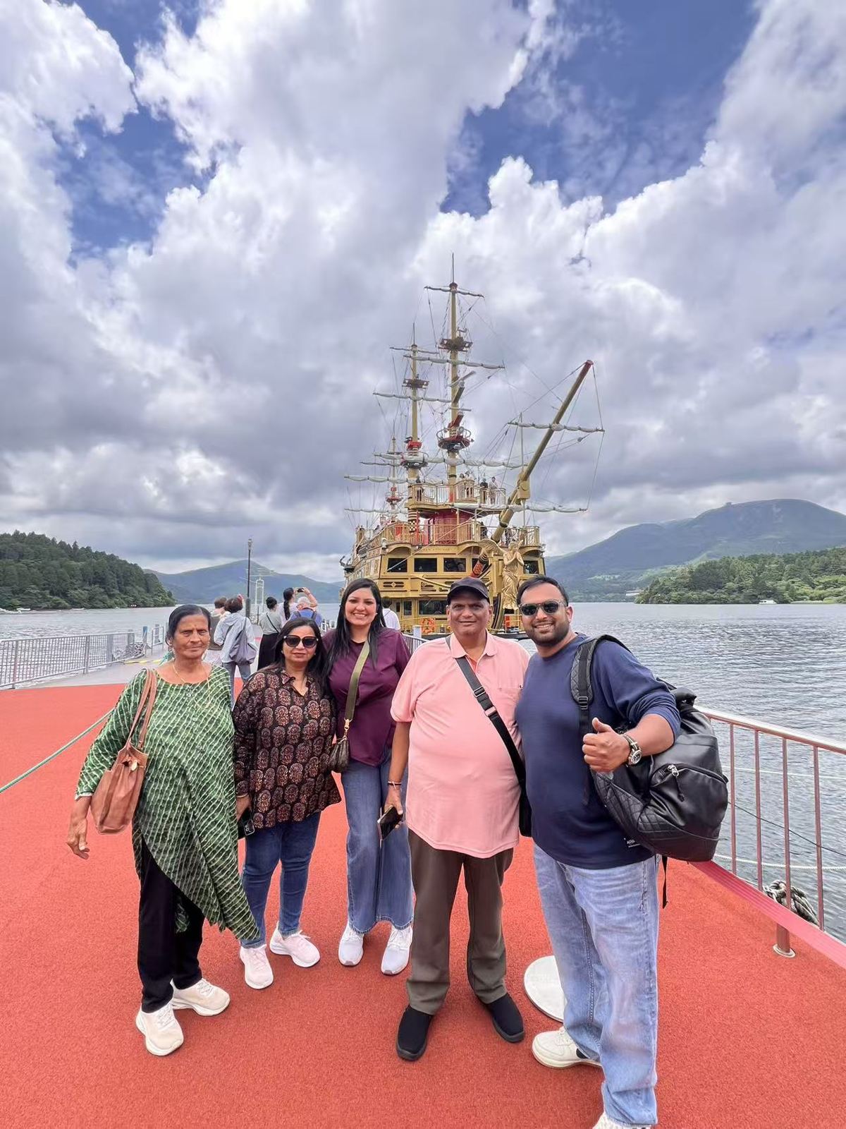 Indian family on the Lake Ashi pirate ship deck in Hakone, traveling with RydAgent, June 2026